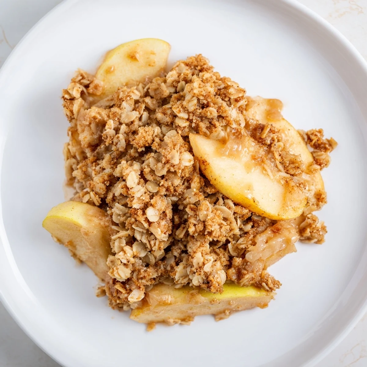 Golden baked Warm Cinnamon Oat Apple Crisp, a delicious American dessert with warm, cinnamony apples.
