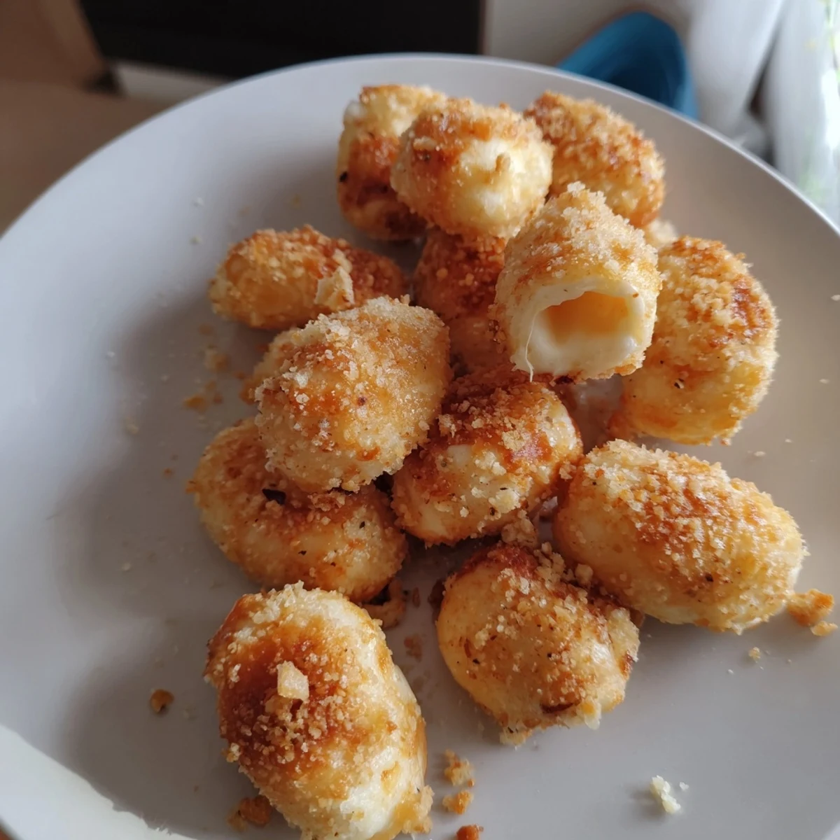 Golden, air fryer mozzarella stick grilled cheese fingers, ready to dip in warm marinara sauce.