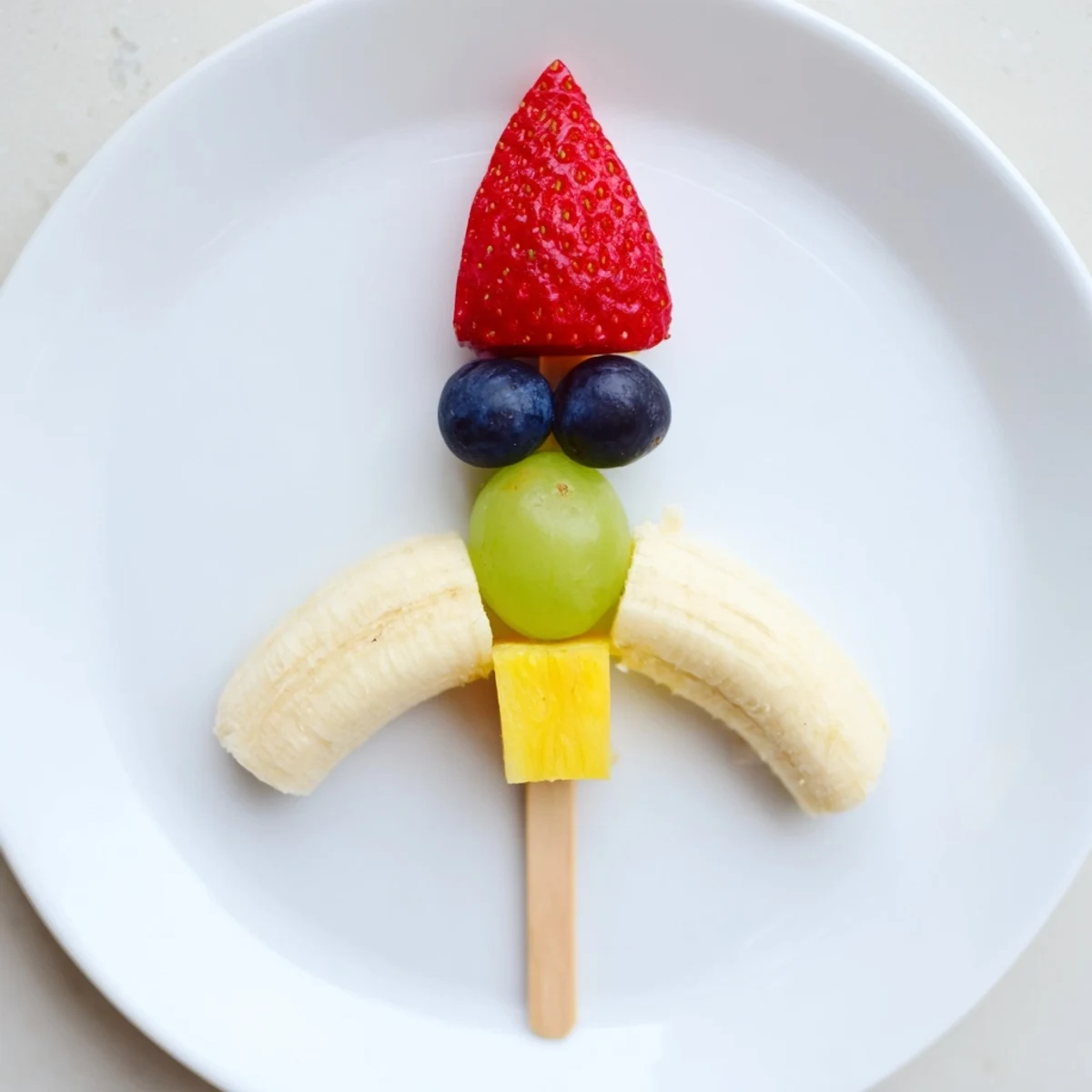 Vibrant Rocket Ship Fruit Skewers with strawberries, grapes, and pineapple, a fun, colorful snack.
