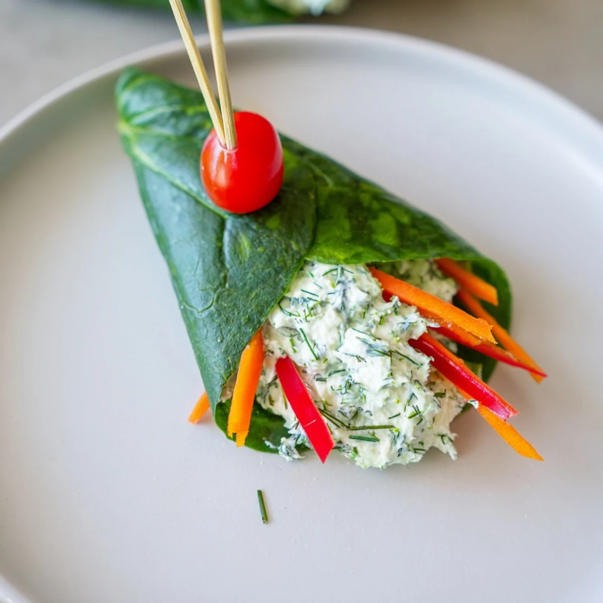 Festive Holly Leaf Spinach Wraps, visually mimicking a holly sprig, filled with creamy cheese and veggies.