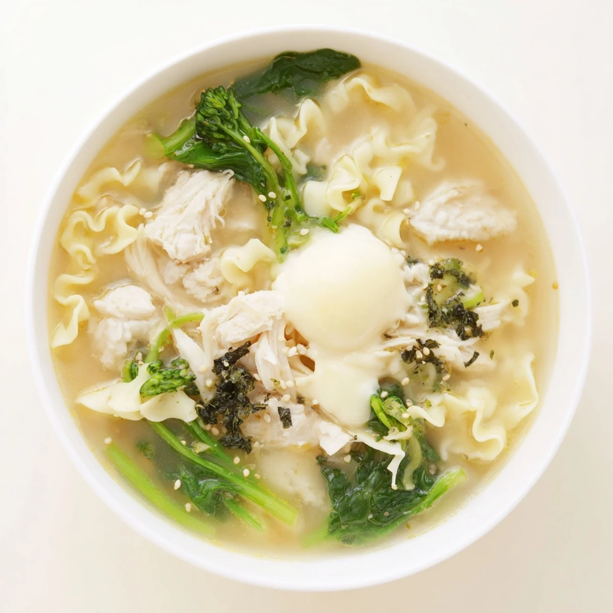 Steaming bowl of Chicken Ramen with Kewpie Mayo, topped with soft egg and scallions, delicious and fast.