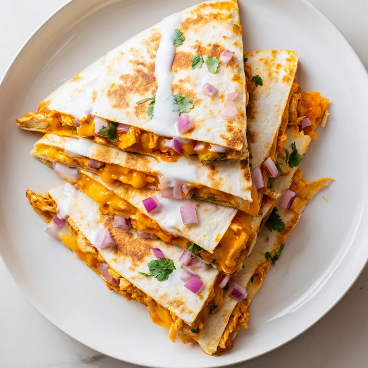 A close-up of a flavorful Buffalo Chicken Quesadilla, filled with chicken, vegetables, and creamy ranch, ready to serve!