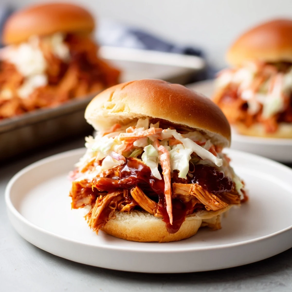 Tender BBQ jackfruit sliders on toasted buns, brimming with smoky vegan pulled pork and coleslaw.