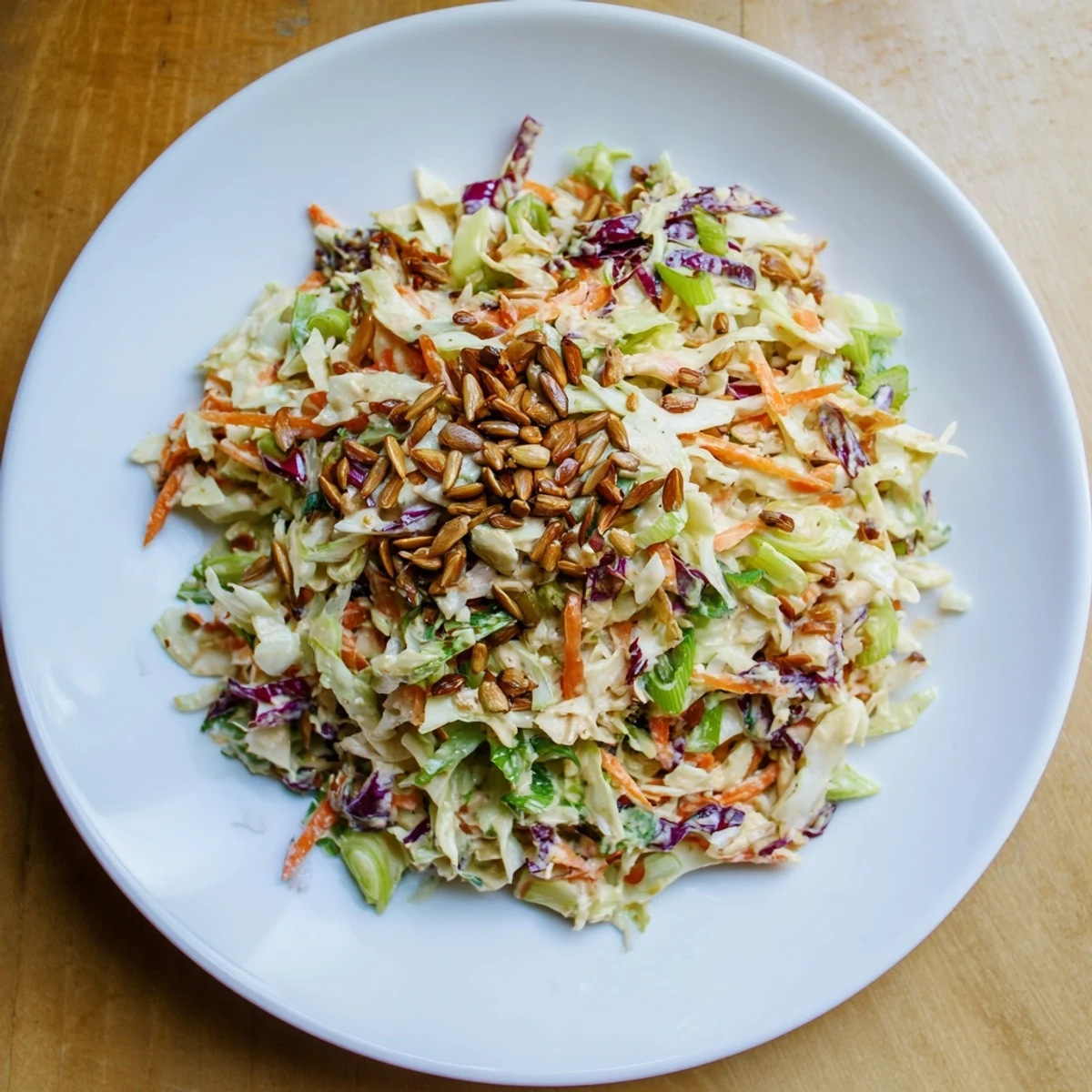 Refreshing Crunchy Coleslaw Salad topped with sunflower seeds, a perfect American side dish.