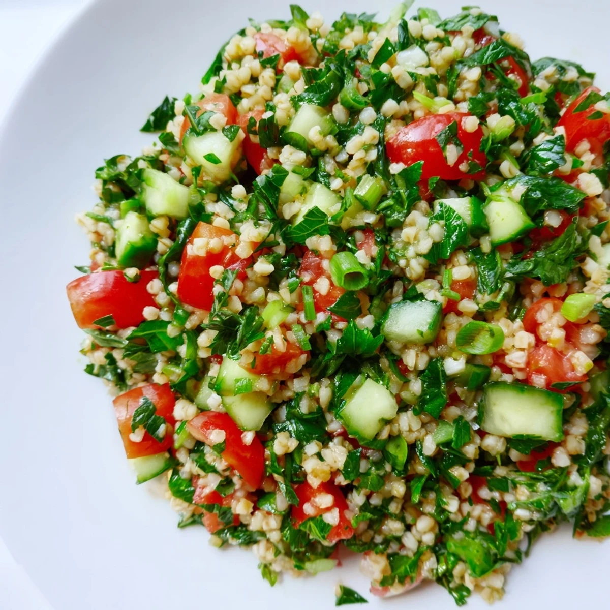 Freshly tossed Bulgur Wheat Salad Tabbouleh in a rustic ceramic bowl, ready to be enjoyed as a light vegetarian side dish.