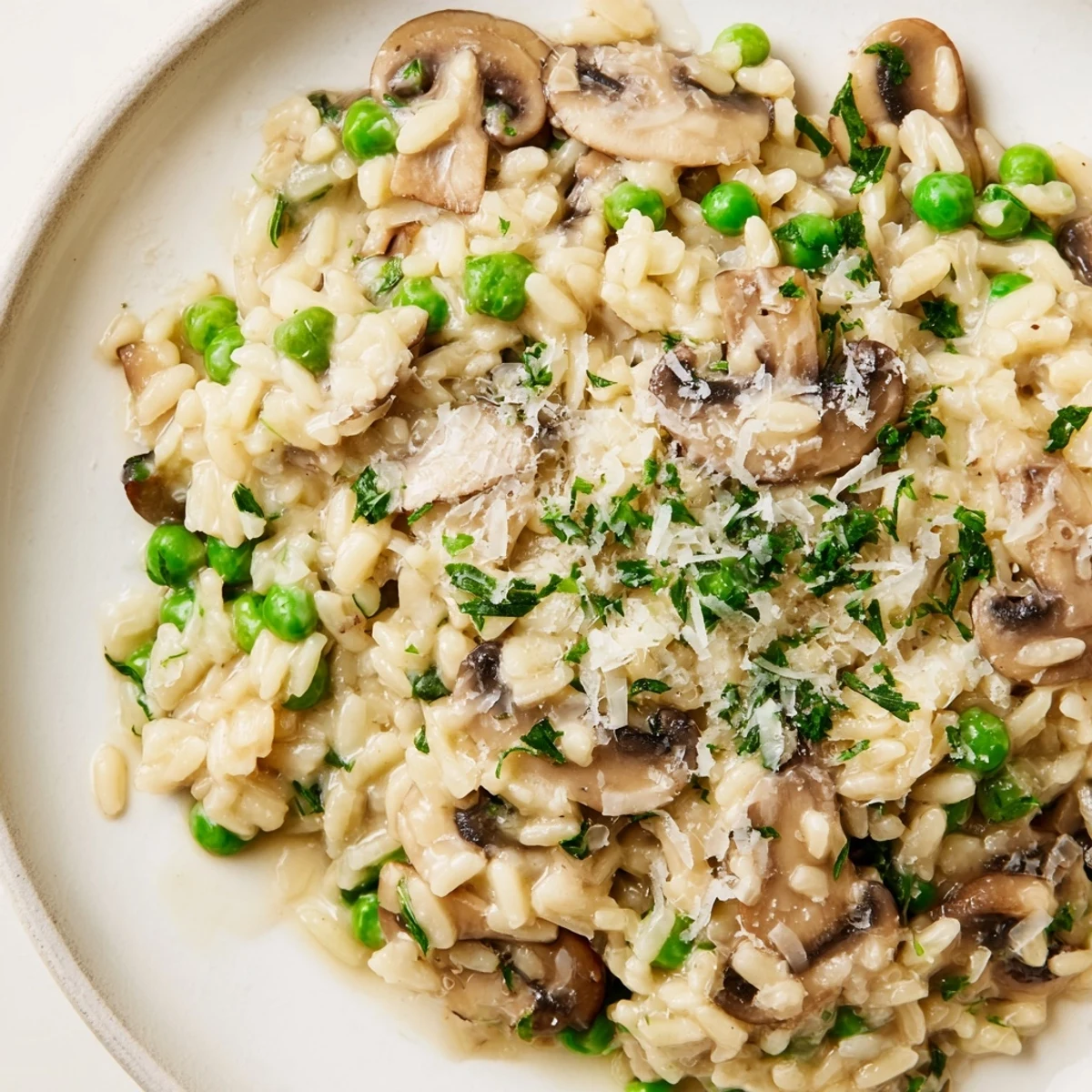 Hearty orzo mushroom risotto-style skillet with caramelized mushrooms, melted Parmesan, and a side of sparkling white wine for a cozy vegetarian dinner.