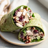 Freshly assembled Cranberry Pecan Chicken Salad Christmas Wraps, boasting visible pecans and a creamy filling, ready for lunch.
