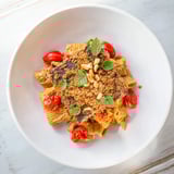 Golden-topped Baked Goat Cheese Snowflake Tomato Basil Pasta with roasted tomatoes and basil.