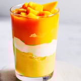 Beautiful, layered ombre in a glass with a Tropical Sunset Smoothie, perfect for a summer breakfast.