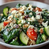 Colorful diced cucumber and red bell pepper add crunch to the wholesome Spinach and Feta Grain Bowl, finished with a lemony dressing.