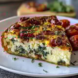 Fluffy spinach and feta frittata with sun-dried tomatoes, perfect for a light Mediterranean brunch or dinner.