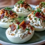Smoked salmon deviled eggs garnished with chives and everything seasoning, a flavorful appetizer for any occasion.