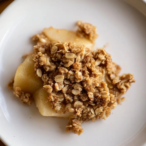 Warm Cinnamon Oat Apple Crisp bubbling hot after baking, with a cinnamon-oat crumble ready to serve.
