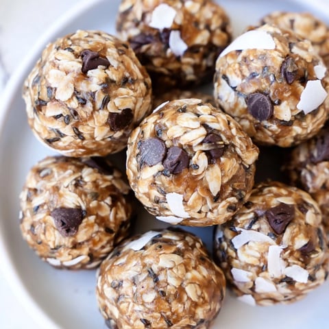 Golden, no-bake Almond-Chia Energy Bites ready to eat, a perfect healthy snack on a plate.