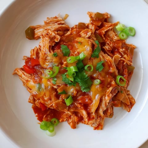 Steaming hot Chicken Enchilada Skillet, a one-pan meal with melted cheese and fresh cilantro.