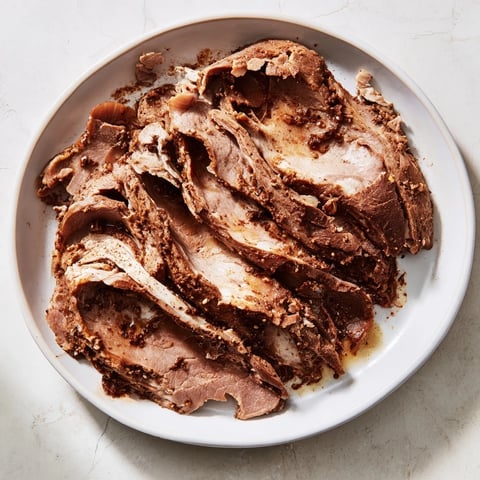 Savory Turkish döner meat, expertly sliced, ready to be wrapped in warm pita with fresh vegetables.