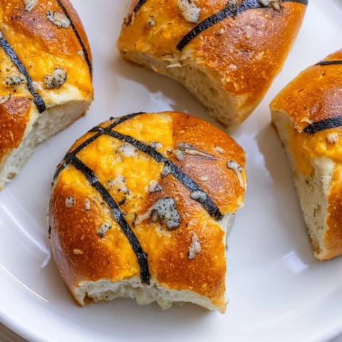 Warm, cheesy Slam Dunk Basketball Pizza Bites with black olive lines, perfect appetizer snack.