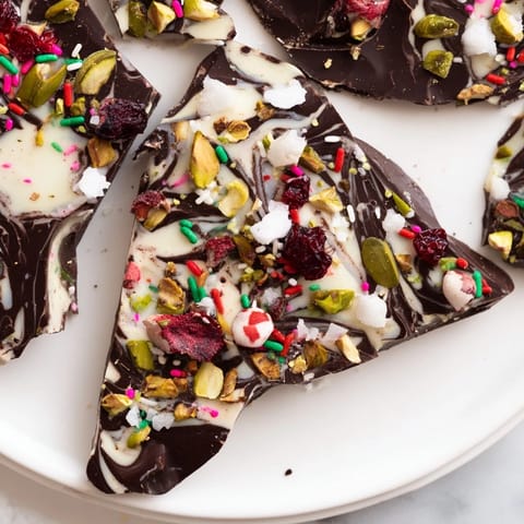 A close-up of delicious Holiday Bark, with vibrant red cranberries and bright green pistachios.
