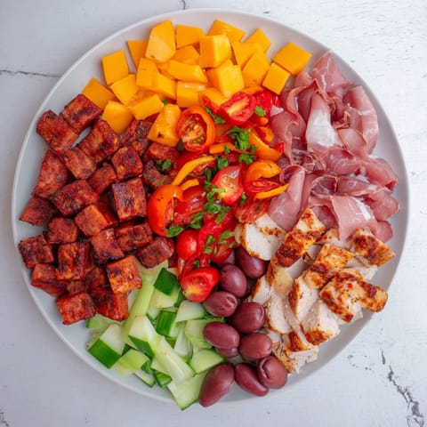 Delicious Keto Power Plate, showcasing savory meats and cheeses alongside vibrant, crisp vegetables for a healthy meal.