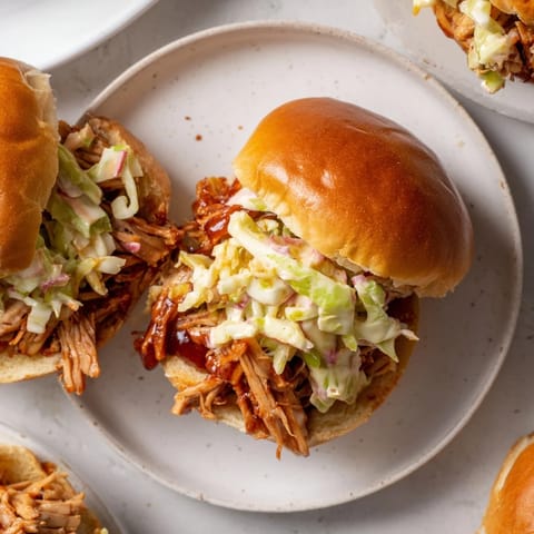 A close-up of flavorful BBQ jackfruit sliders, perfect plant-based pulled pork sandwiches ready to eat.
