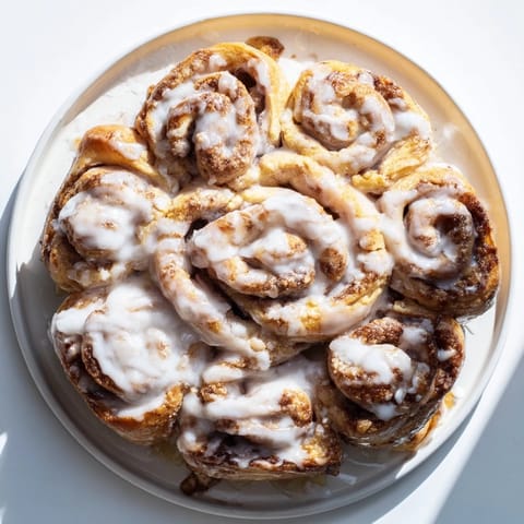 A delicious, shareable Cinnamon Roll Pull-Apart Snowflake, boasting swirls of cinnamon sugar baked to perfection, awaiting your bite.