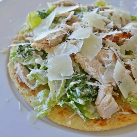 Golden-baked flatbread loaded with juicy sliced chicken, crisp romaine, and Parmesan cheese.