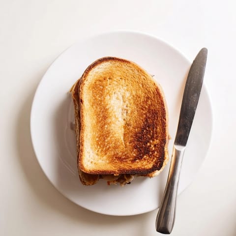 Perfectly melted cheese oozes from this crispy Turkey Club Grilled Cheese, layered with smoky bacon, tender turkey, fresh lettuce, and tomato on golden sourdough bread.