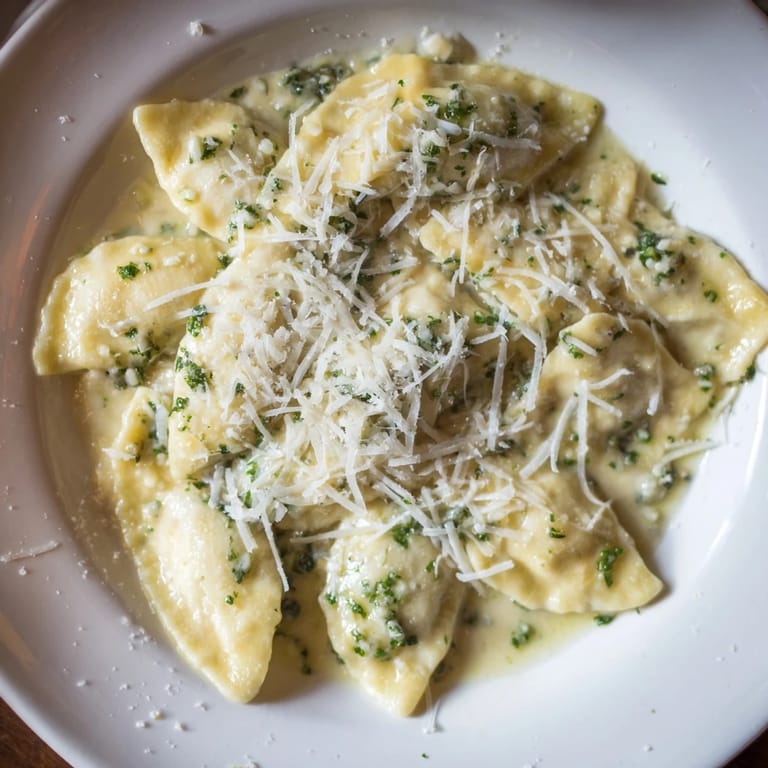 A close-up shot of the finished 15-Minute Garlic Parmesan Pasta, ready to serve with extra cheese and herbs.