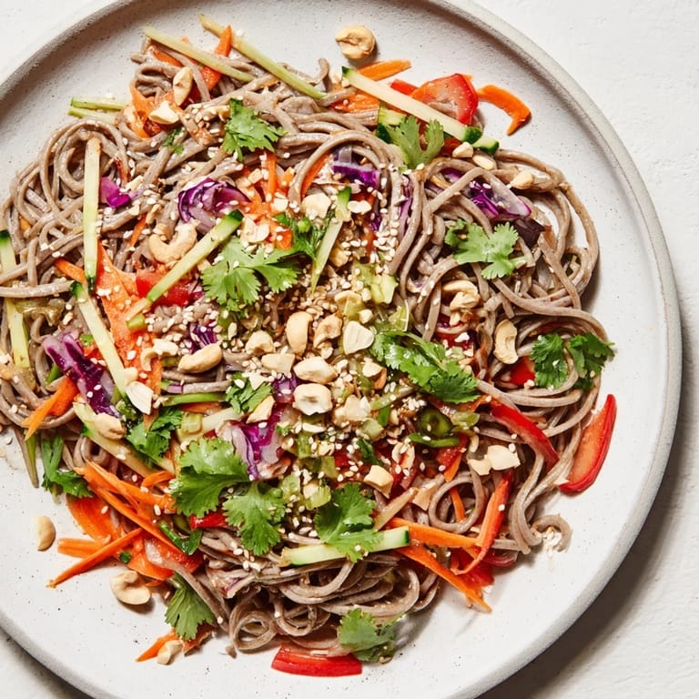 Vibrant cold noodle salad boasts a flavorful sesame-ginger dressing, offering a refreshing light meal.