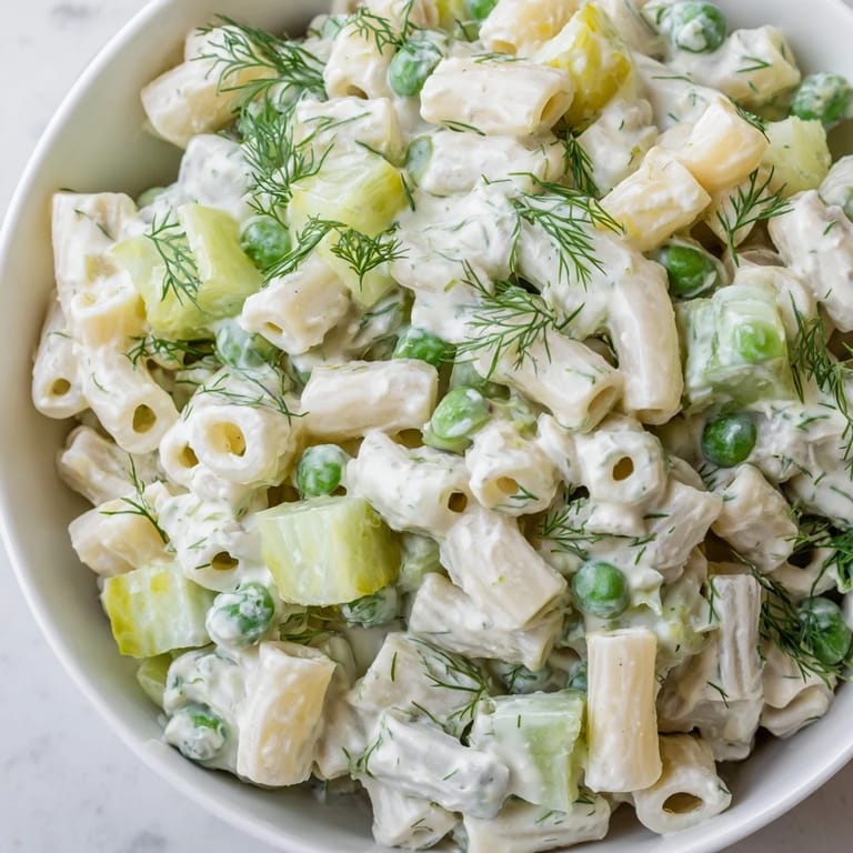 Close-up of Creamy Dill Pickle Pasta Salad with creamy dressing, ditalini pasta, and crunchy dill pickle pieces, ready to serve.