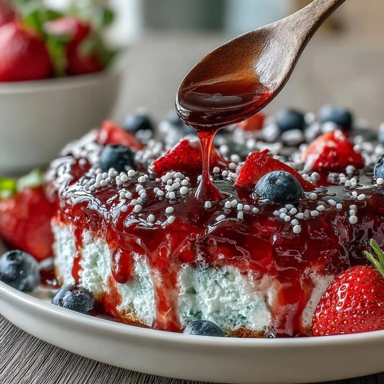 This Red White Blue Poke Cake offers delightful fruity swirls and a cool, refreshing finish.